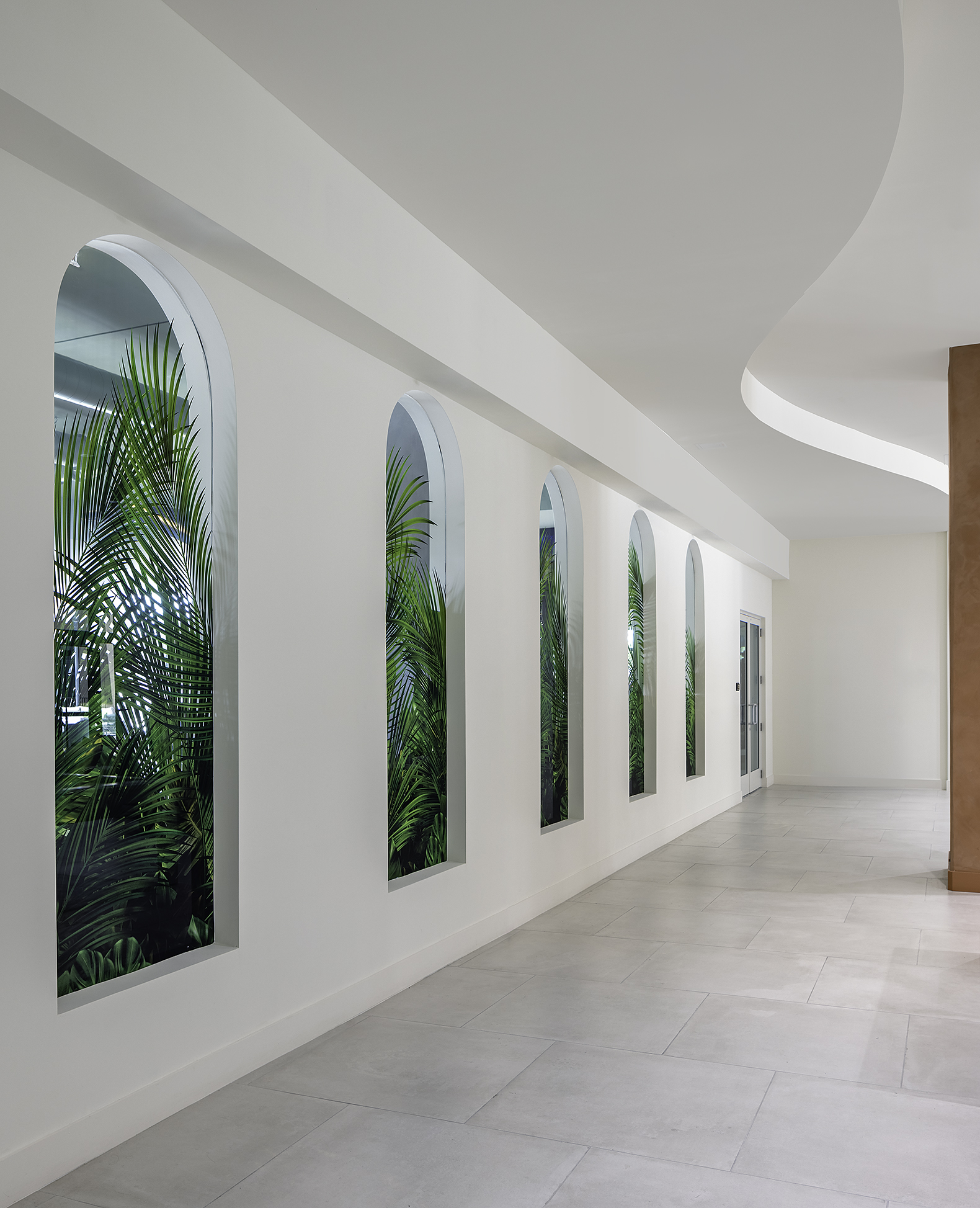 Hallway with arched windows and greenery