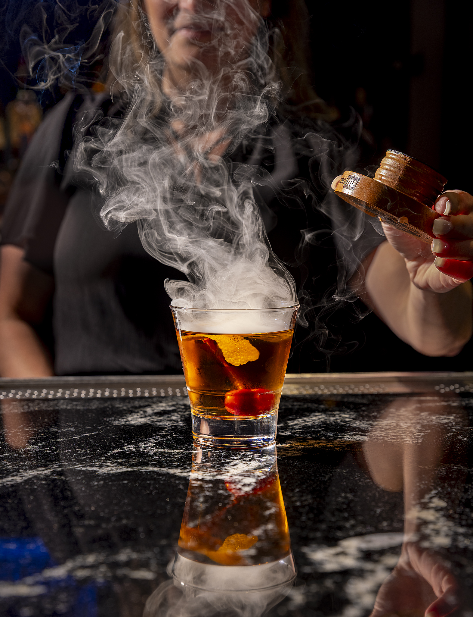 Dramatic smoked cocktail at the bar