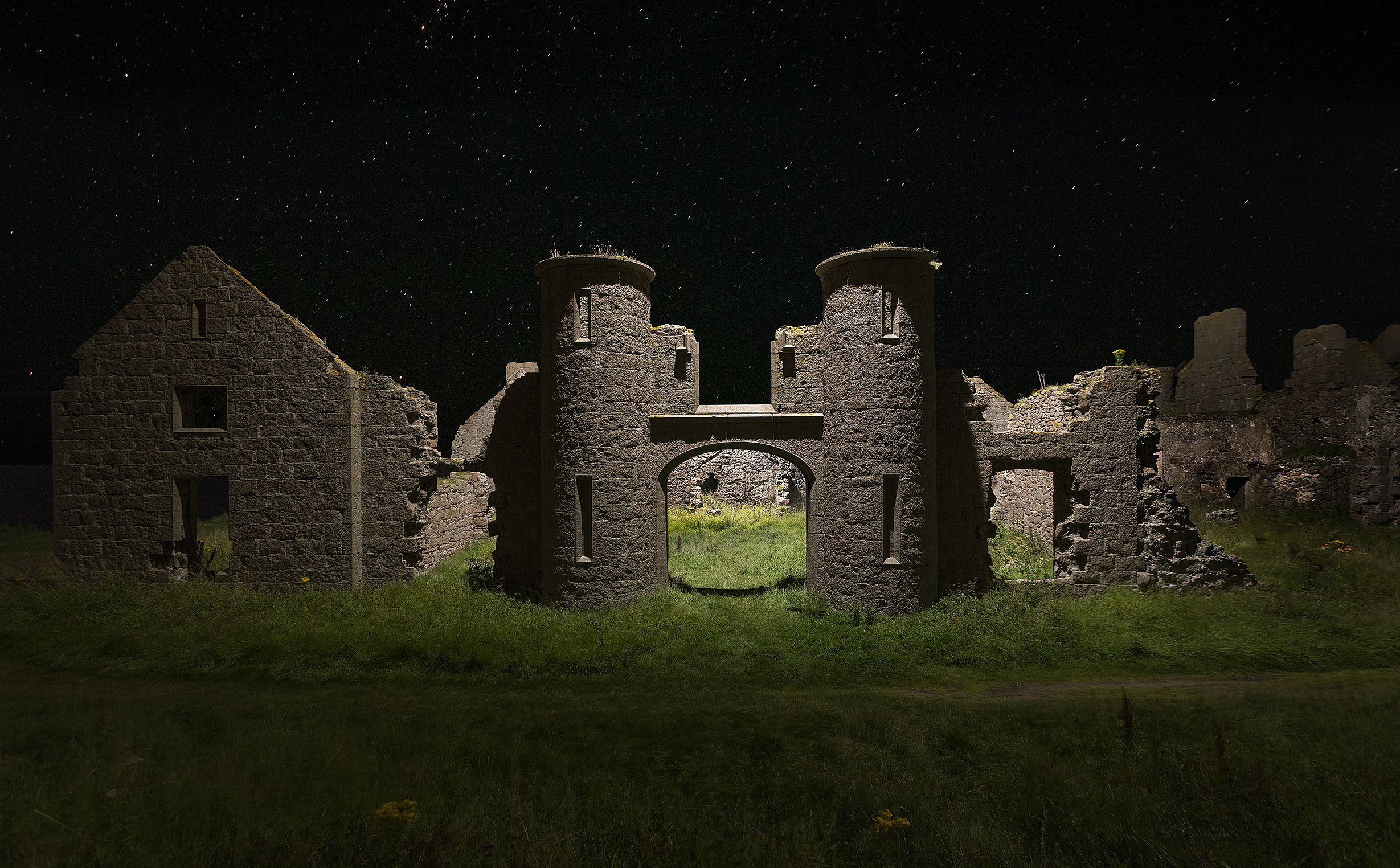 Slains Castle under the stars, lit dramatically