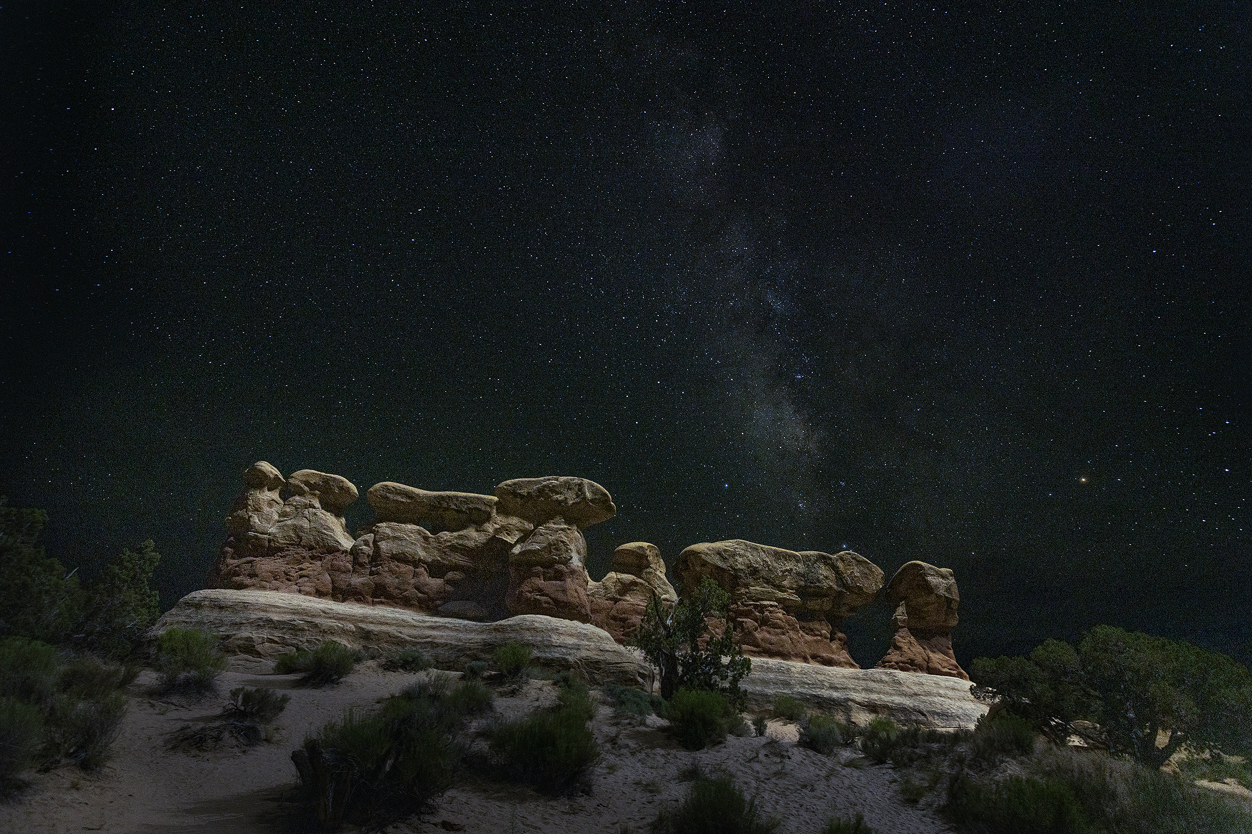 A long procession of caprock hoodoos under the Milky Way at night, Devils Garden, Grand Staircase-Escalante National Monument.